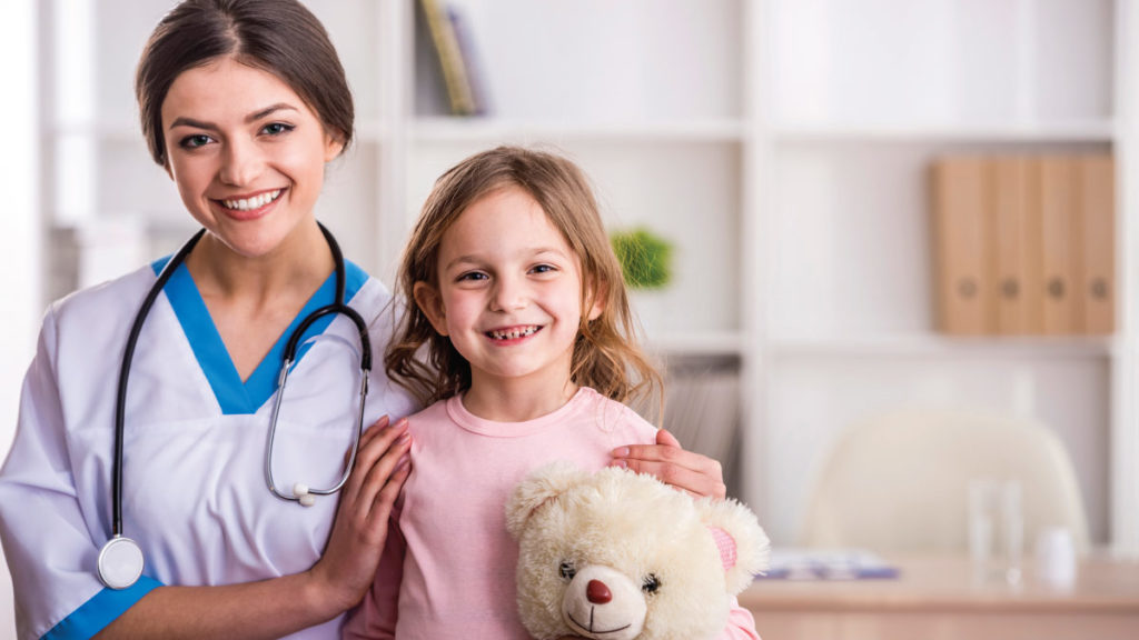 Nurse with young girl and teddy bear