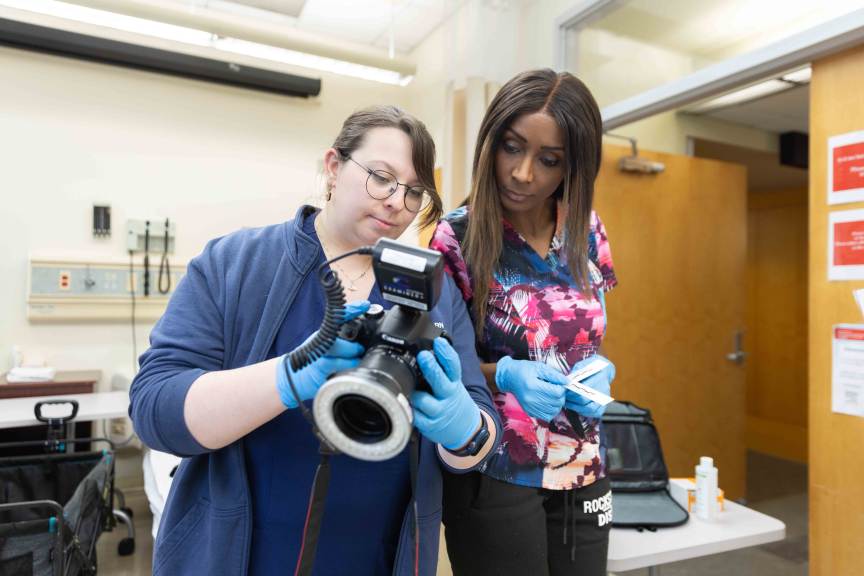 Rutgers School of Nursing students Juliana Edelman and Tiffany Tiffany review forensic photography.