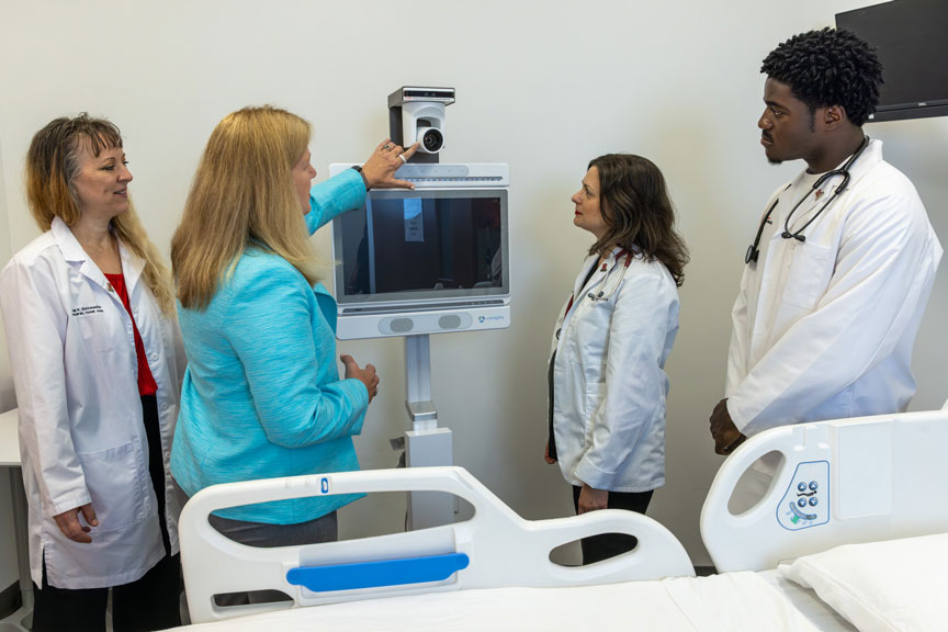 Susan Kristiniak, Caregility chief nursing officer, demonstrates the company’s Connected Care Platform to Angela Starkweather (left), dean and professor Rutgers School of Nursing, and students Julie Cornell and Triumphant Aydodele.
